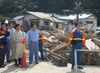 Photograph of the Prime Minister observing an area hit by the typhoon in Nachi-Katsuura Town
