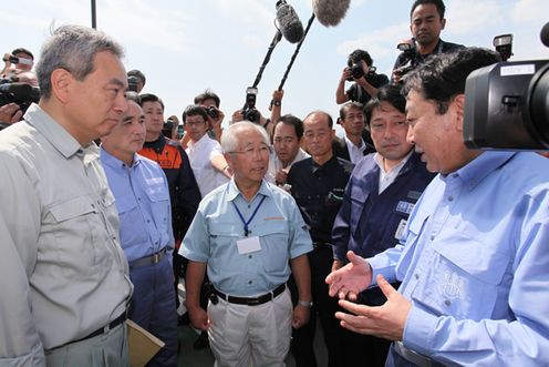 Photograph of the Prime Minister observing the damage to the fish market in Kesennuma City