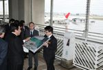 Photograph of the Prime Minister observing Naha Airport's runway expansion project