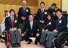 Photograph of the Prime Minister enjoying talks with wheelchair tennis athletes