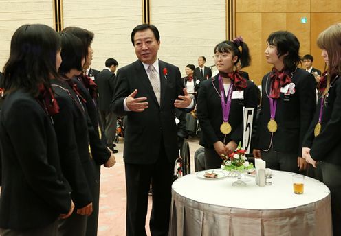 Photograph of the Prime Minister enjoying talking with goalball athletes